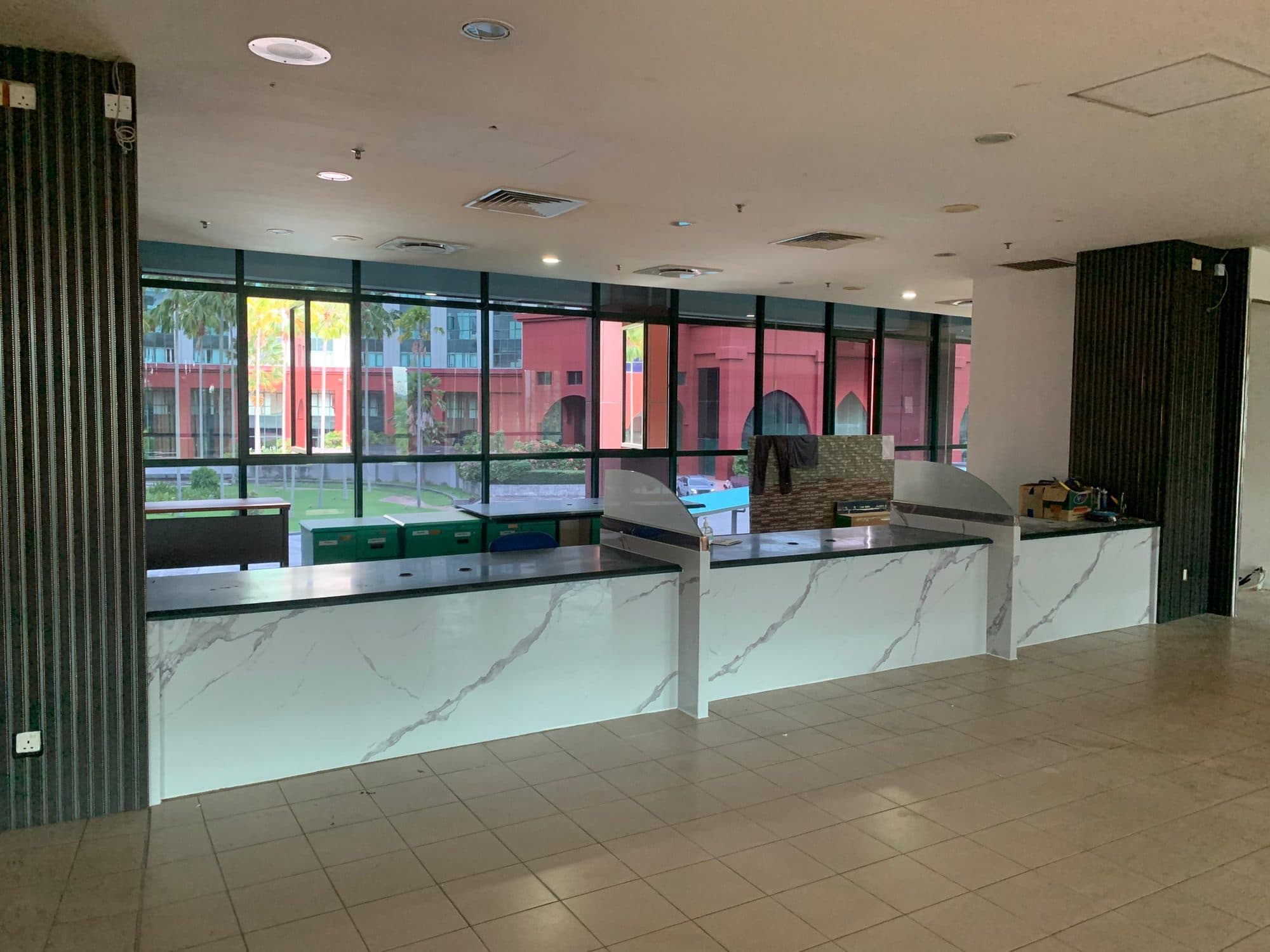 Jabatan Imigresen — service counter in marble sheet with fluted panel columns
